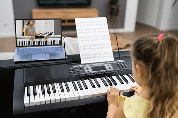 Little girl taking online piano class